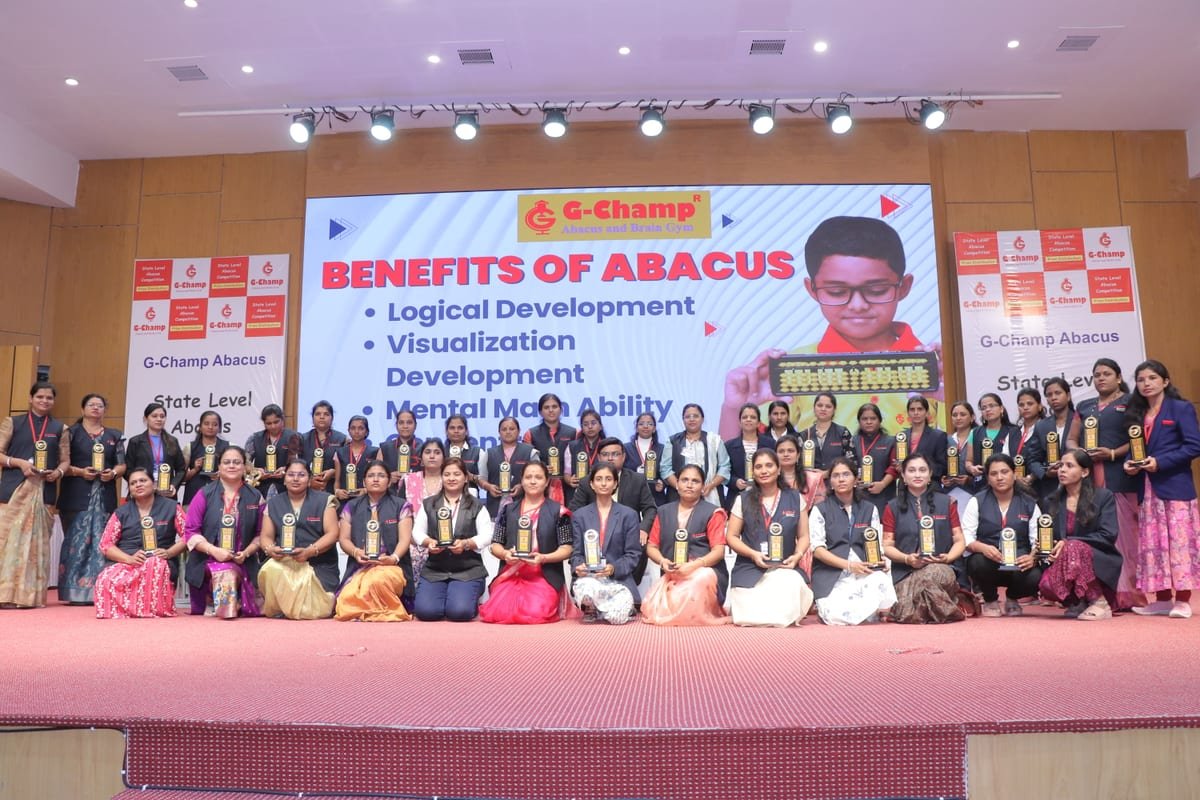 Large group of G-Champ franchise partners holding their awards at a State Level Abacus Competition event